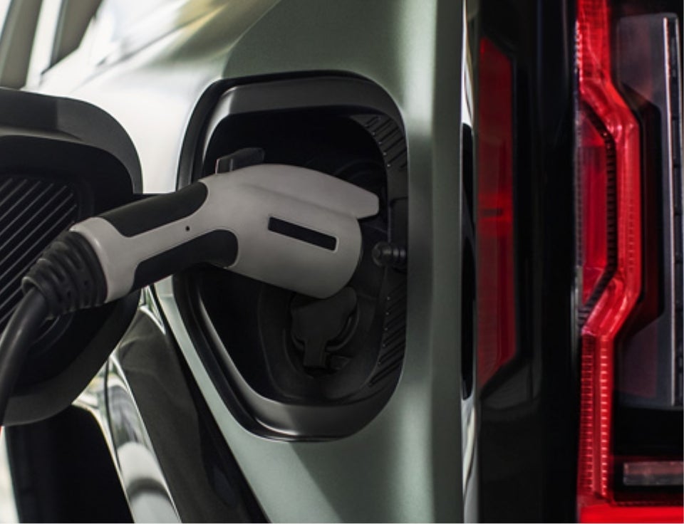 Close up of charging port with charger plugged in on a GMC Hummer EV SUV - D'ELLA Buick GMC in QUEENSBURY NY